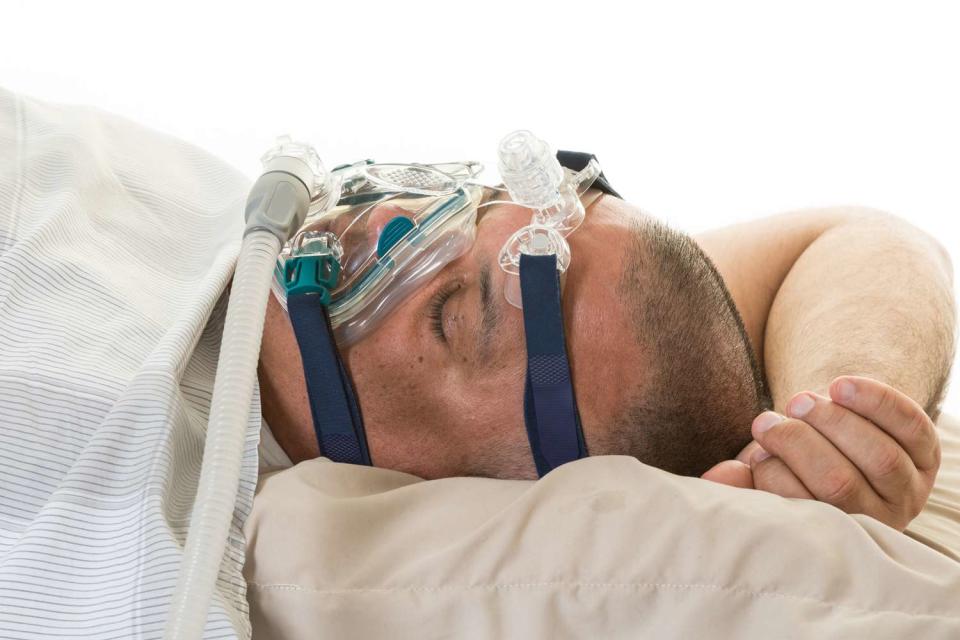 <p>Roberto Machado Noa/LightRocket via Getty</p> Man using sleep apnea device.