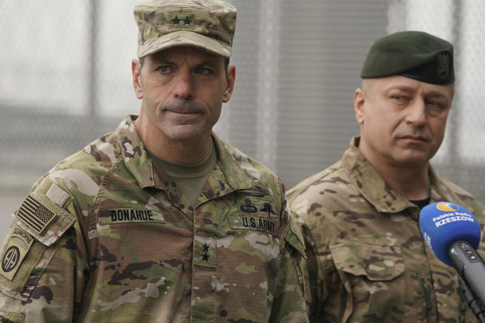 US Army General Christopher Donahue, left, commanding general of the 82nd Airborne Division, and Polish General Wojciech Marchwica speak to journalists after unloading vehicles from a transport plane arriving from Fort Bragg at the Rzeszow-Jasionka airport in southeastern Poland, on Sunday, Feb. 6, 2022. Additional U.S. troops are arriving in Poland after President Joe Biden ordered the deployment of 1,700 soldiers here amid fears of a Russian invasion of Ukraine. Some 4,000 U.S. troops have been stationed in Poland since 2017. (AP Photo)
