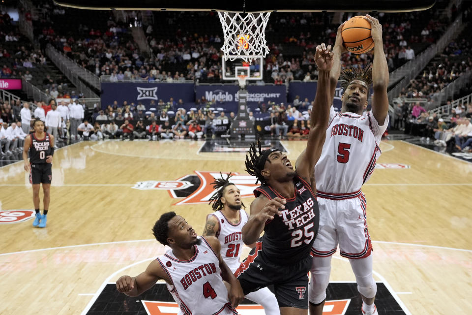 Houston forward Ja'Vier Francis (5) beats Texas Tech forward Robert Jennings (25) to a rebound during the first half of an NCAA college basketball game in the semifinal round of the Big 12 Conference tournament, Friday, March 15, 2024, in Kansas City, Mo. (AP Photo/Charlie Riedel)