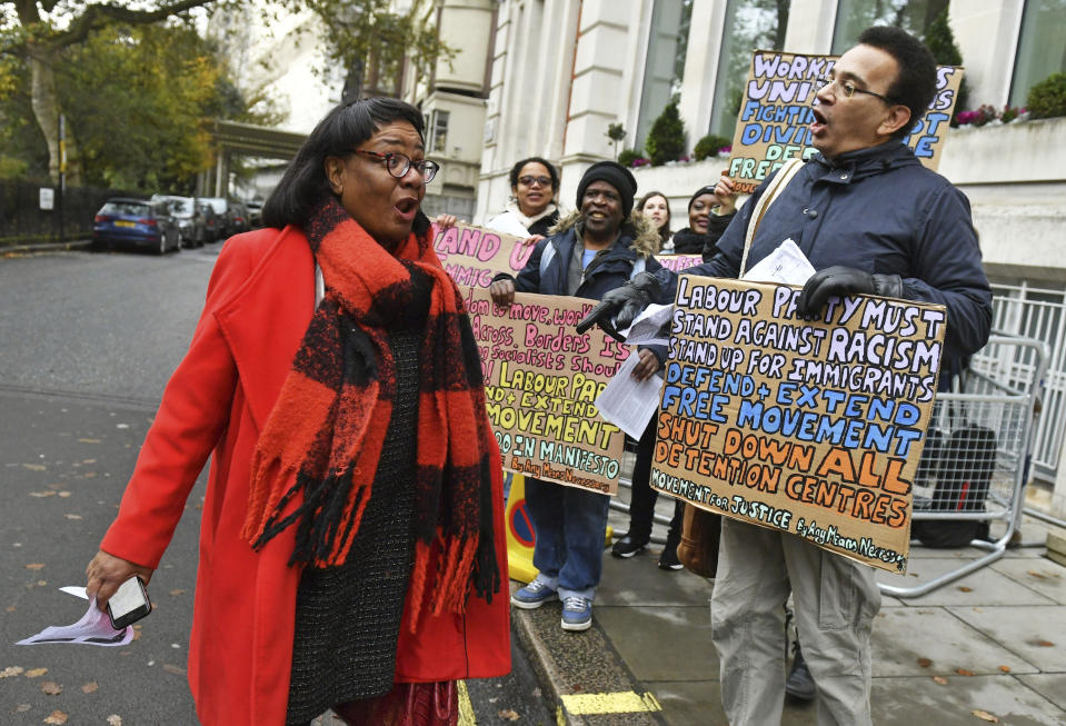 Britain's main opposition Labour Party Shadow home secretary Diane Abbott is greeted by pro-immigration protesters ahead of a meeting to finalise the manifesto details that will form Labour Party policy for the upcoming General Election in London, Saturday Nov. 16, 2019. Britain's Brexit is one of the main issues for voters and political parties as the UK goes to the polls in a General Election on Dec. 12. (Dominc Lipinski/PA via AP)