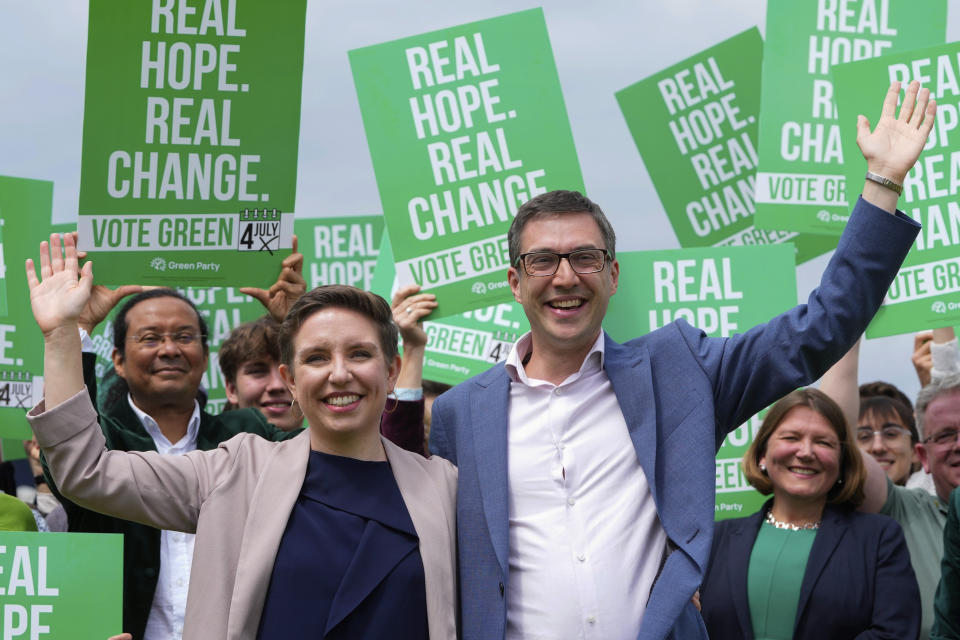 FILE - Green Party co-leaders Adrian Ramsay, right, and Carla Denyer pose with supporters at their General Election Manifesto launch in Hove, England, on June 12, 2024. United Kingdom voters will cast ballots in a national election Thursday, passing judgment on Sunak’s 20 months in office, and on the four Conservative prime ministers before him. (AP Photo/Kirsty Wigglesworth, File)