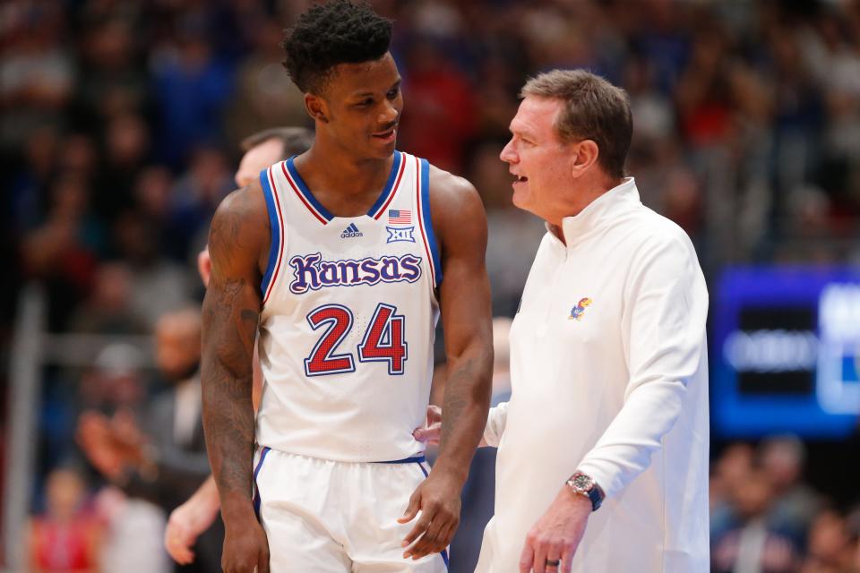 Kansas junior forward KJ Adams Jr. (24) exchanges words with coach Bill Self during the second half of Friday's game against UConn inside Allen Fieldhouse.