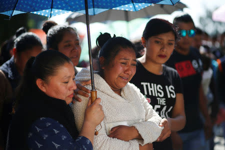 Residents react after a mass for their relative who died during the explosion of a fuel pipeline ruptured by oil thieves, in the municipality of Tlahuelilpan, state of Hidalgo, Mexico January 22, 2019. REUTERS/Mohammed Salem