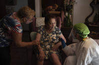 In this Friday, July 31, 2020 file photo, Dr. Marta Ruberte, right, talks to 94-year-old Maria Lluisa Olivella during a home visit in Sant Sadurní d'Anoia, Catalonia region, Spain. Olivella was feeling tired but according to the Doctor is not suspected of having coronavirus. In contrast to the darkest weeks of March and April, when the virus ripped through Spain's elderly in nursing homes and pushed the country's hospitals to the breaking point, the pressure is now on Spain's neighborhood health clinics. (AP Photo/Felipe Dana)