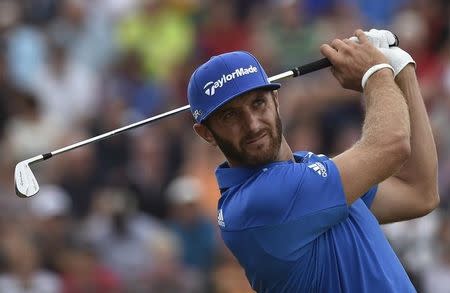 Dustin Johnson of the U.S. watches his tee shot on the fourth hole during the final round of the British Open Championship at the Royal Liverpool Golf Club in Hoylake, northern England July 20, 2014. REUTERS/Toby Melville/Files