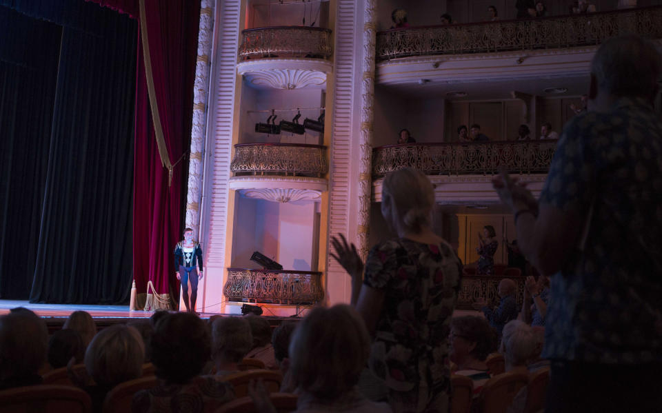 In this Oct. 29, 2018 photo, Cuban expatriate ballet dancer Taras Domitro receives a standing ovation at the grand theater in Havana, after his return to Cuba. "This is the correct path," said Domitro, who defected during a tour of Canada in 2007, one of the highest-profile departures from Alonso's company. "We're talking about ballet, we have nothing to do with politics." (AP Photo/Desmond Boylan)