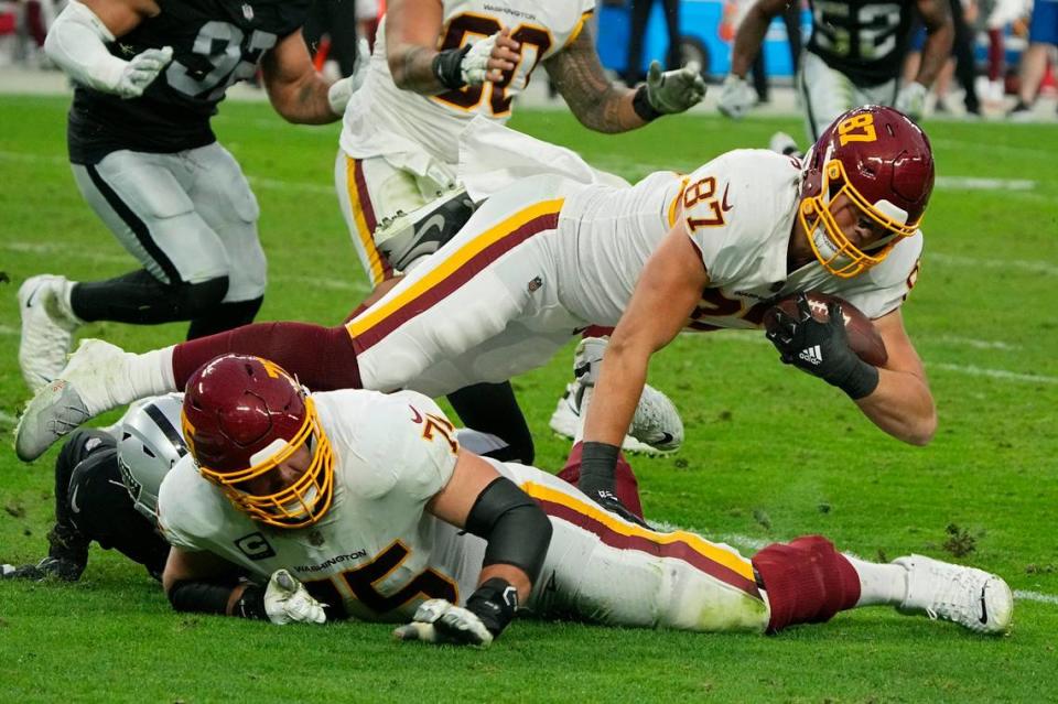 Washington Football Team tight end John Bates is tackled after making a catch against the Las Vegas Raiders during the second half of their game Sunday in Las Vegas.