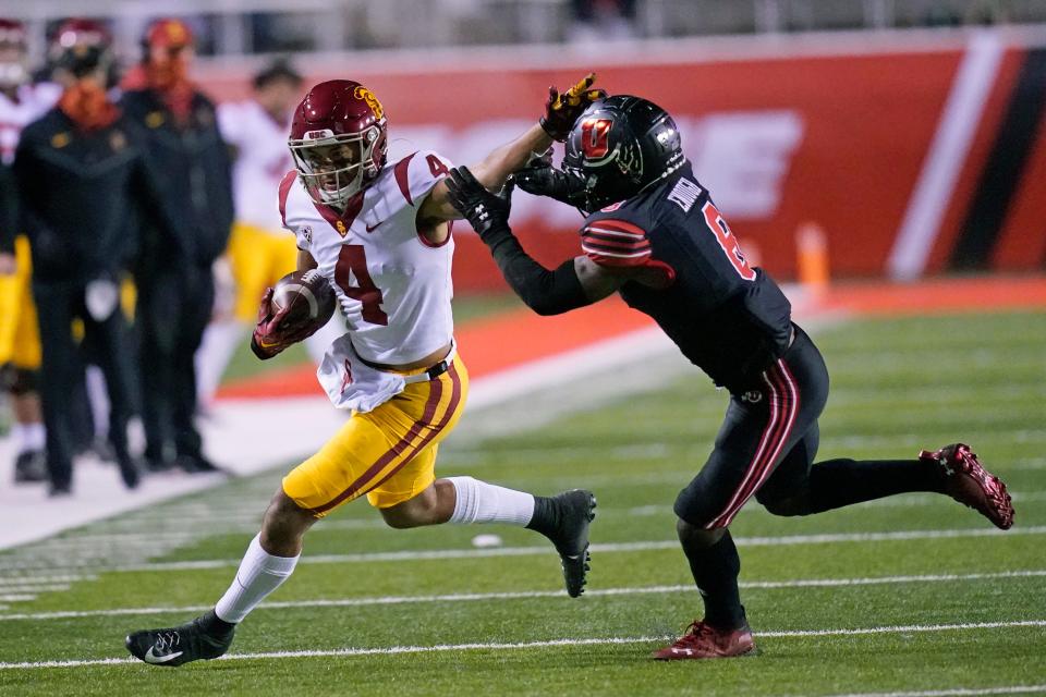 Utah cornerback Clark Phillips III (8) tackles Southern California wide receiver Bru McCoy (4) during the first half during an NCAA college football game Saturday, Nov. 21, 2020, in Salt Lake City. (AP Photo/Rick Bowmer)