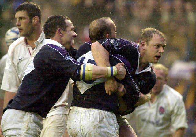 Duncan Hodge (right) is mobbed by team-mates after scoring his try in a famous victory over England