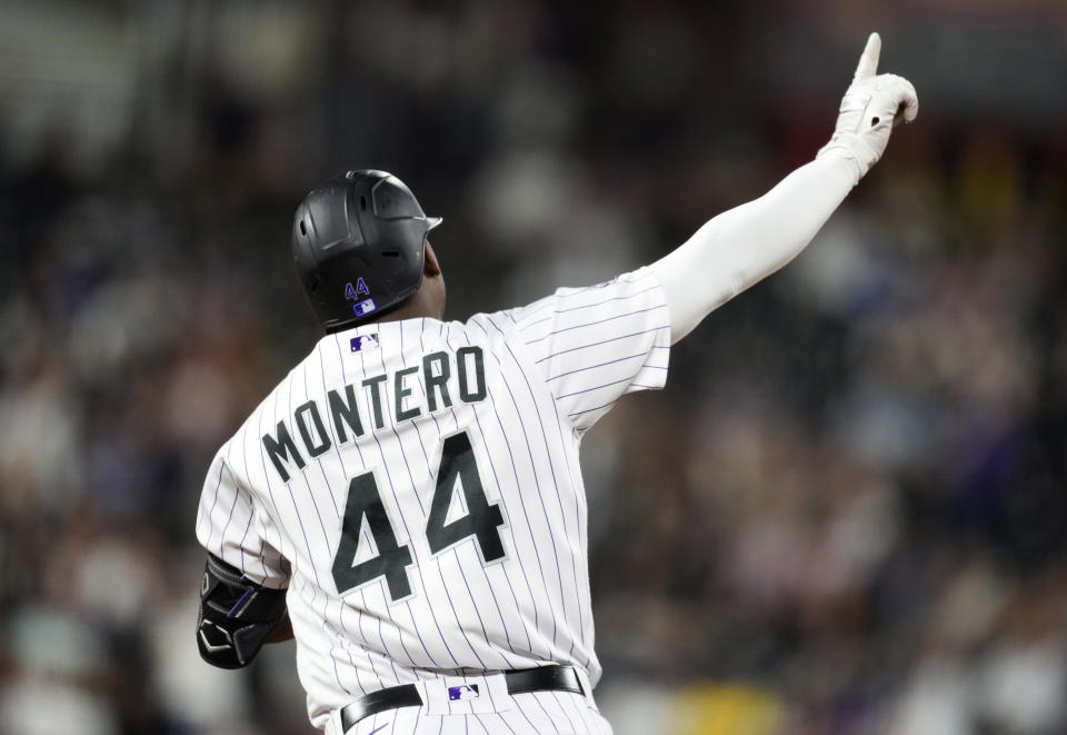 Colorado Rockies' Elehuris Montero gestures to the bullpen as he rounds first base after hitting a two-run home run off Los Angeles Dodgers starting pitcher Ryan Yarbrough during the third inning of a baseball game Thursday, Sept. 28, 2023, in Denver. (AP Photo/David Zalubowski)