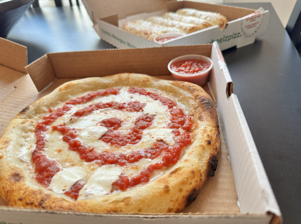 Wheelz Pizza’s three-cheese pizza and cheesy garlic parmesan breadsticks.