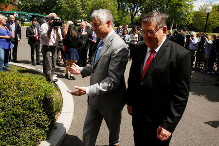 U.S. Representative Fred Upton (R-MI) (C) and Representative Michael Burgess (R-TX) (R) return to the West Wing after speaking to reporters about health care legislation after meeting with President Trump at the White House in Washington, U.S. May 3, 2017. REUTERS/Jonathan Ernst