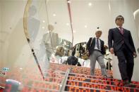 People walk down the stairways of the Uniqlo Global flagship store during a preopening in Berlin, April 10, 2014. REUTERS/Axel Schmidt