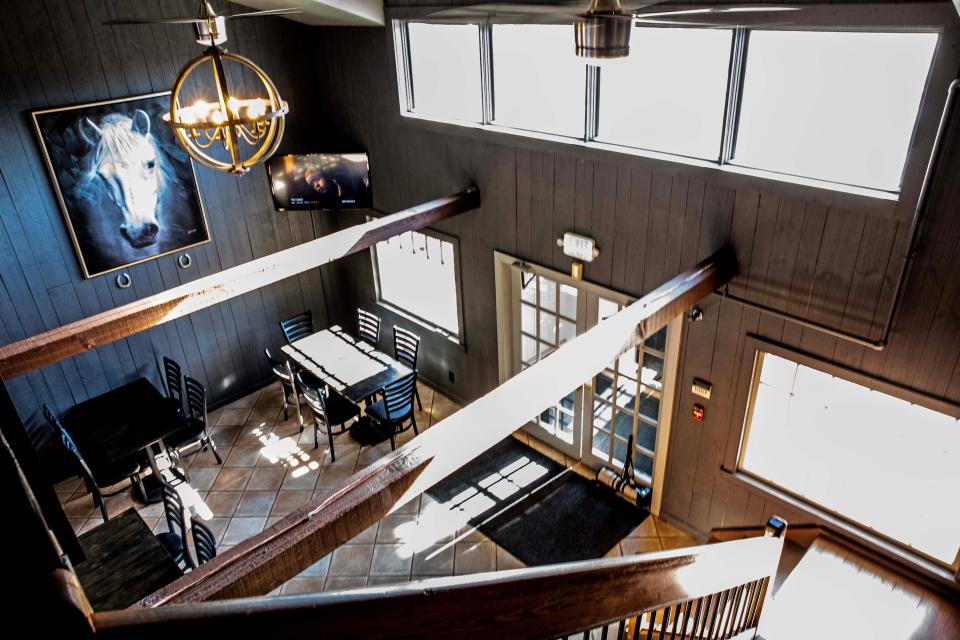 A second-floor view of a seating area at Corner Cove, a two-story restaurant in a converted historic building, is featured in Hockessin, Friday, Dec. 15, 2023. Corner Cove, due to open in late December, will offer local oysters, steamed crab, cheap beer, red-sauce pasta, flame-cooked pizza and more.