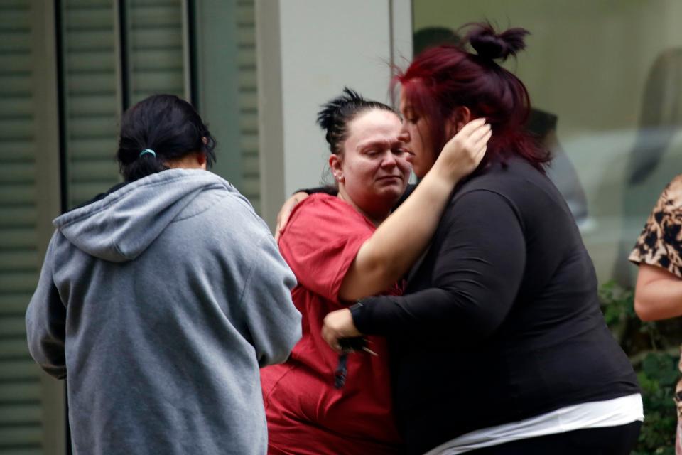People react outside the Civic Center in Uvalde, Texas, Tuesday, May 24, 2022. An 18-year-old gunman opened fire at a Texas elementary school, killing multiple people.