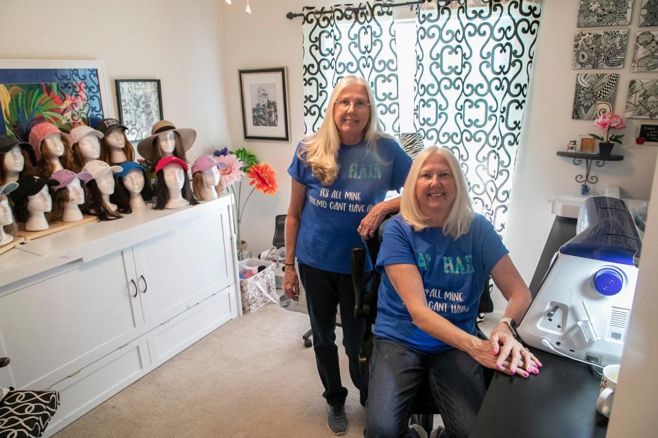 Twin sisters Denise DiFelice, left, and Diane Hamilton make hats with donated hair attached for people going through chemotherapy.