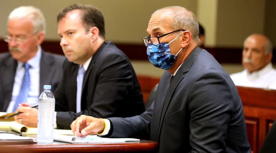 Attorney John Dakmak, left, and former Macomb County prosecutor Eric Smith listen to a witness in the courtroom of visiting judge Cynthia Arvant inside 41B District Court in Clinton Township on July 9, 2021.