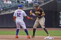 San Diego Padres' Manny Machado, right, and New York Mets shortstop Francisco Lindor tease one another during the first inning of a baseball game at Citi Field, Sunday, June 13, 2021, in New York. (AP Photo/Seth Wenig)