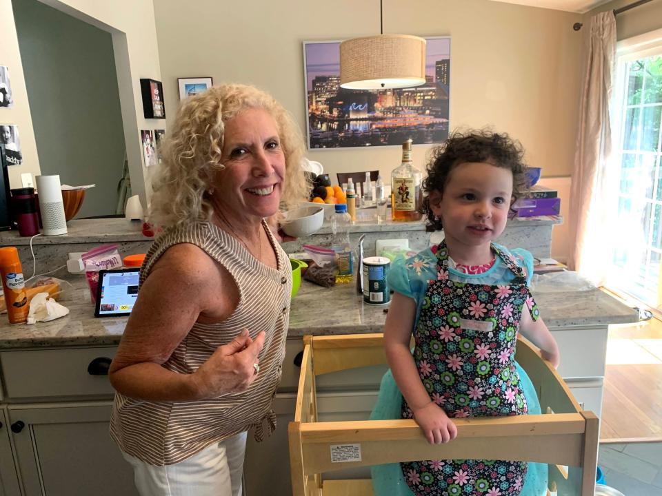 Marjorie Hershberg in a kitchen with her granddaughter, Clara, in a high chair.