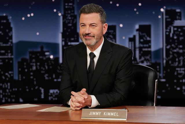 <p>Randy Holmes / ABC via Getty</p> Jimmy Kimmel sits while shooting 'Jimmy Kimmel Live.'