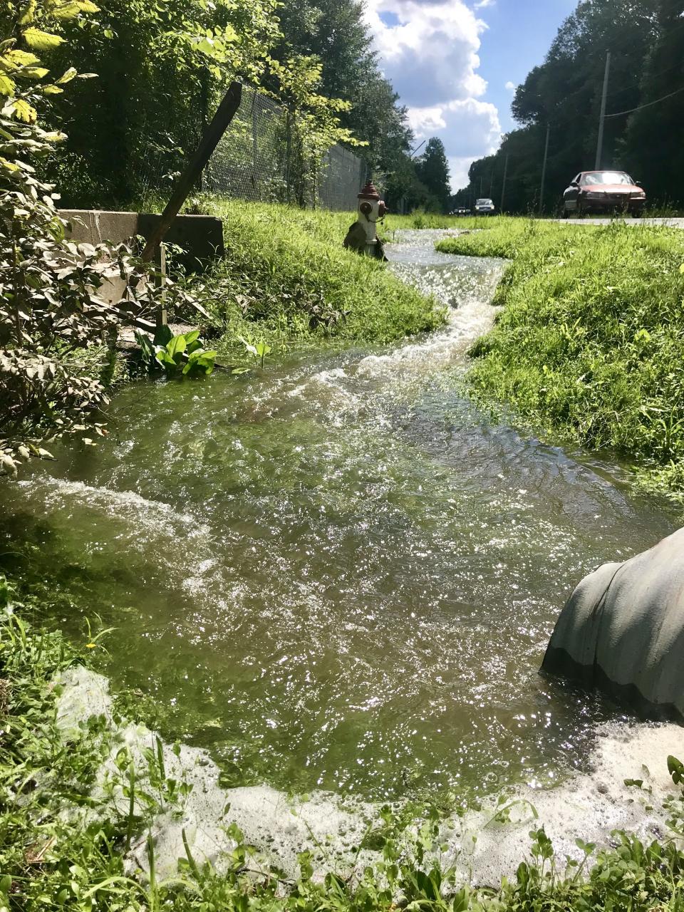 Water flows off the former NAS-JRB Willow Grove property on July 12, 2019. Recent testing shows high levels of unregulated PFAS chemicals continue to appear in off-base waterways such as Park Creek and the Little Neshaminy Creek. [KYLE BAGENSTOSE / STAFF]