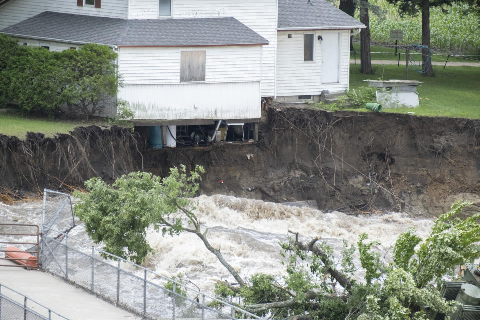 The innards of a house near the Rapidan Dam in Rapidan, Minn., are visible as waters from the Blue Earth River rush by, Monday, June 24, 2024. (Casey Ek/The Free Press via AP)