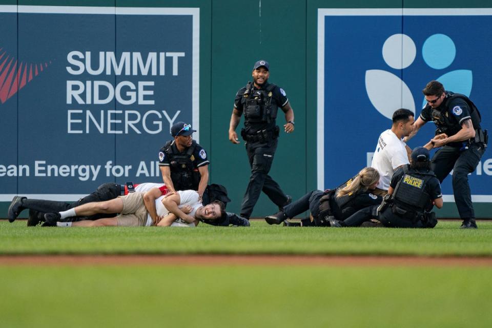 Security tackle the protesters (Reuters)