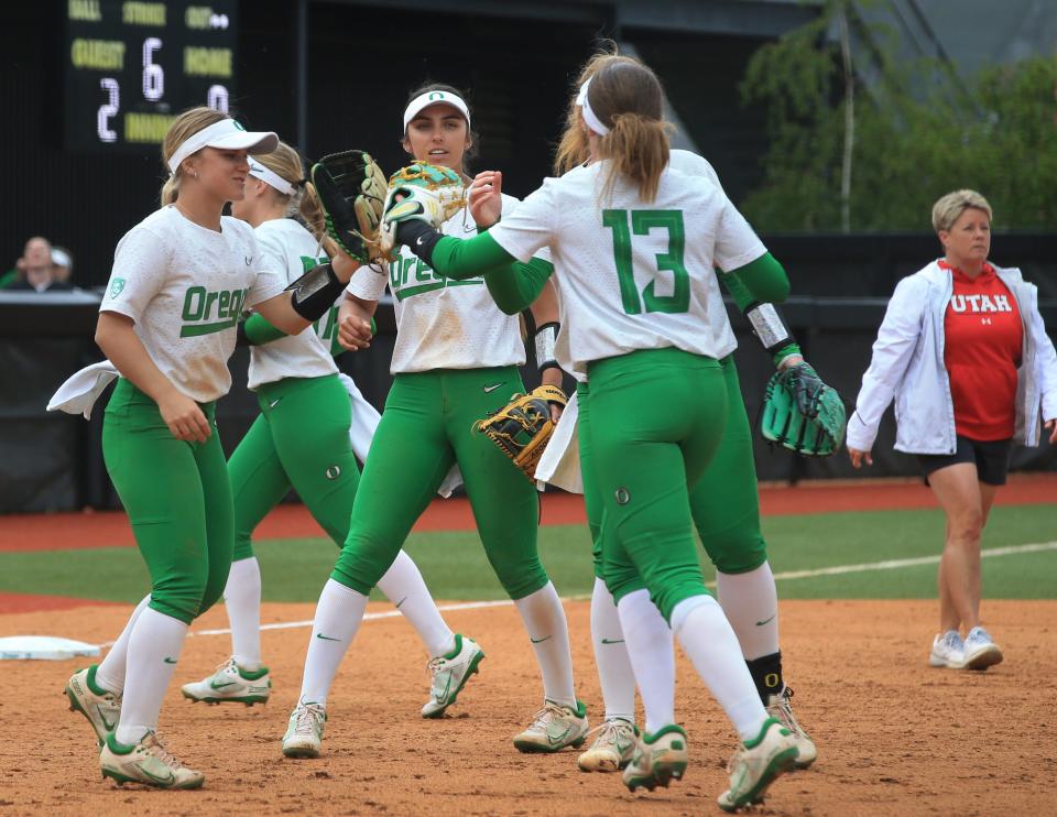 Oregon players celebrate getting out of an inning against Utah on May 7 in Eugene.