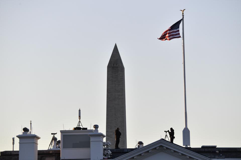 Security is posted atop the White House in Washington, D.C. as Marine One is scheduled to depart the White House in Washington, D.C., en route Joint Base Andrews, Maryland on January 20, 2021.