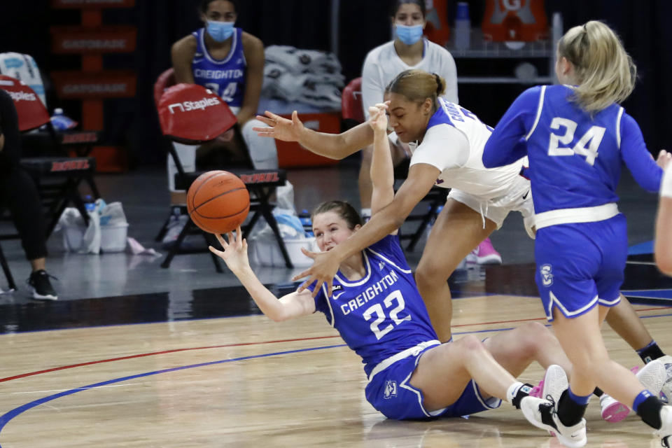 DePaul guard Deja Church, right, blocks the pass of Creighton 's Carly Bachelor during the first half of an NCAA college basketball game Saturday, Feb. 20, 2021, in Chicago. (AP Photo/Shafkat Anowar)
