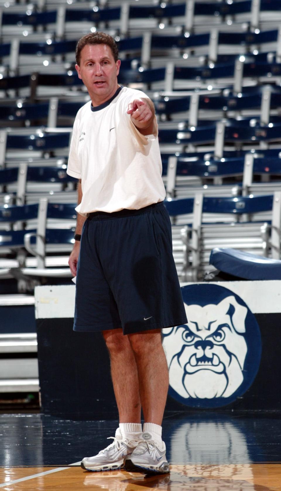 ** ADVANCE FOR WEEKEND NOV. 22-23 ** Butler University men's basketball coach Todd Lickliter directs his players in stretching exercises during practice Thursday Nov. 20, 2003 in Indianapolis, Ind. Despite the the loss of six seniors from last years squad, the Bulldogs have set a goal to compete for the national championship. (AP Photo/AJ Mast)