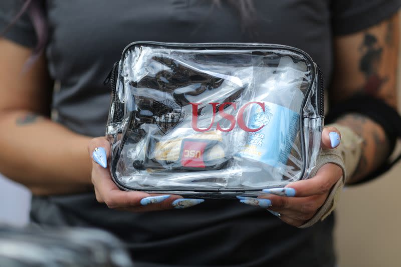 A woman hands out sanitizer kits on the USC campus, amid the outbreak of the coronavirus disease (COVID-19), in Los Angeles