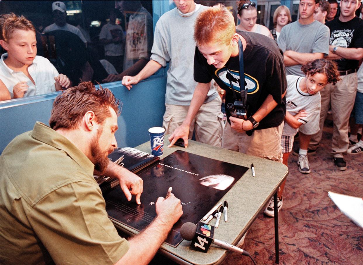 The Blair Witch Project co-producer Gregg Hale signs a poster from his movie for Pearce Combest of Henderson at Old Orchard Cinemas Aug. 6, 1999. Hale came to Henderson to meet and greet fans and to see his movie in the theater he patronized as a kid.