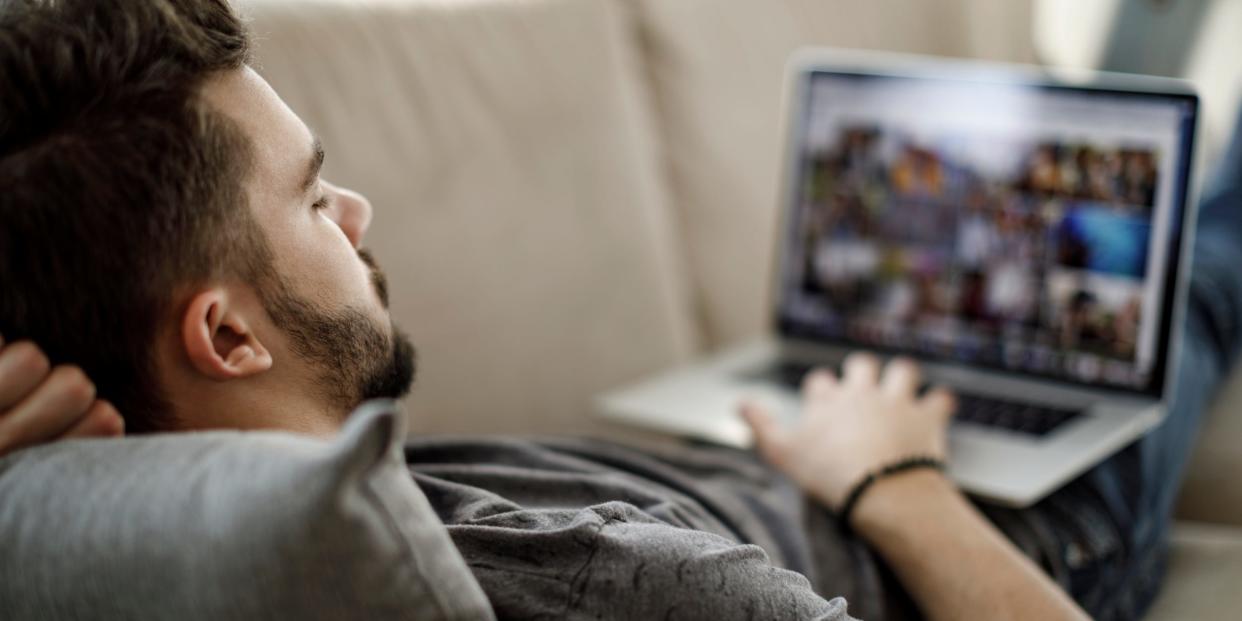 man using laptop watching shows