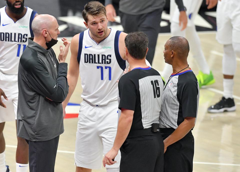 CLEVELAND, OHIO - MAY 09: Head coach Rick Carlisle and Luka Doncic #77 of the Dallas Mavericks argue with referees David Guthrie #16 and Michael Smith #38 during the third quarter of the game between the Dallas Mavericks and the Cleveland Cavaliers at Rocket Mortgage Fieldhouse on May 09, 2021 in Cleveland, Ohio. NOTE TO USER: User expressly acknowledges and agrees that, by downloading and/or using this photograph, user is consenting to the terms and conditions of the Getty Images License Agreement. (Photo by Jason Miller/Getty Images)