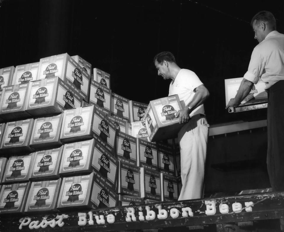 Pabst Brewery workers Thomas Parnouskis (left) and Vernon J. Reichgeld load the first truckload of Pabst headed for Milwaukee County Stadium in 1953.