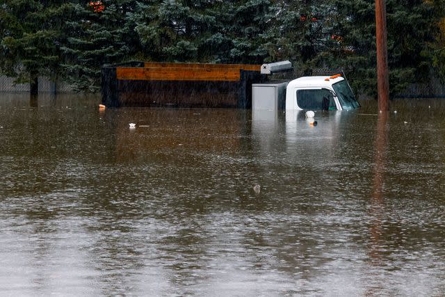 <p>Kena Betancur/Getty Images</p> A truck submerged in flood water in Elmsford, New York