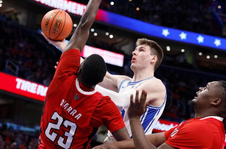Duke’s Kyle Filipowski (30) drives to the basket past N.C. State’s Mohamed Diarra (23) during the first half of N.C. State’s game against Duke in the quarterfinal round of the 2024 ACC Men’s Basketball Tournament at Capital One Arena in Washington, D.C., Thursday, March 14, 2024. Ethan Hyman/ehyman@newsobserver.com