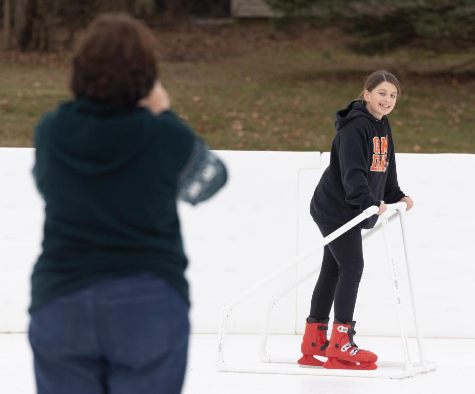Nancy Hawk of Brewster takes a picture of her granddaughter Ava Hawk, 11, of Massillon as she learns to skate at Wampler Park in Massillon.