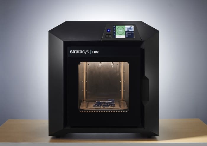 A black 3D printer with the Stratasys corporate logo displayed on the front.