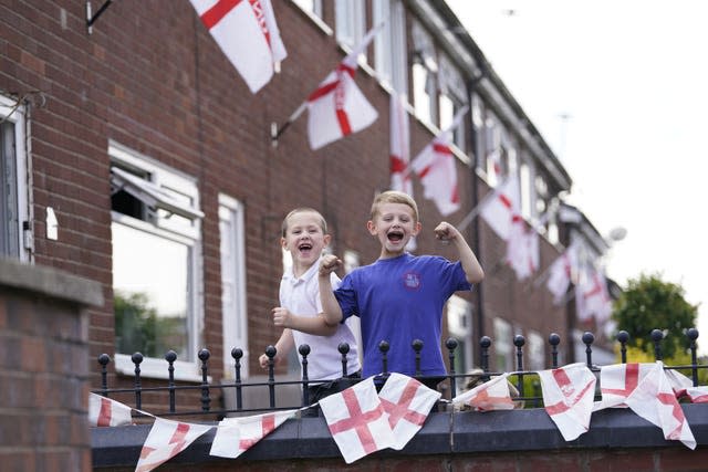 Noah Butterworth (left) and Harry Chamberlain on Wales Street in Oldham, where residents have renamed the road England Street ahead of the final 