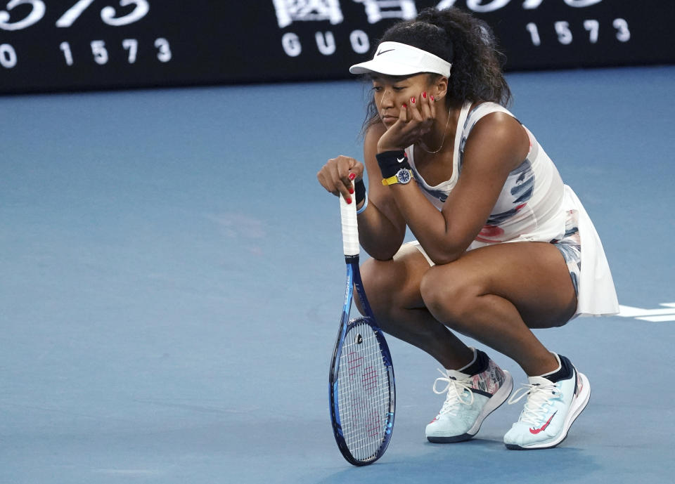 Japan's Naomi Osaka reacts during her third round loss to Coco Gauff of the U.S. at the Australian Open tennis championship in Melbourne, Australia, Friday, Jan. 24, 2020. (AP Photo/Lee Jin-man)