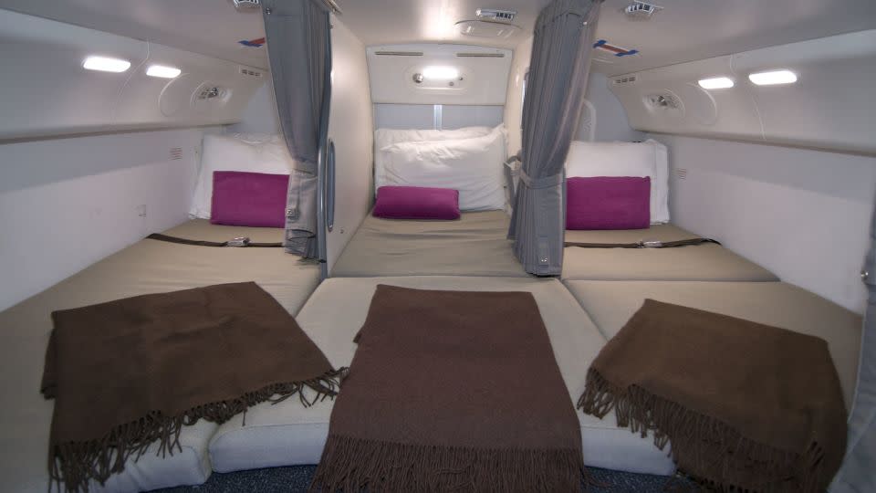 Flight attendants on long-haul flights are provided with spaces to rest. Here's a photo of the crew rest area on a Boeing 787. - Boeing