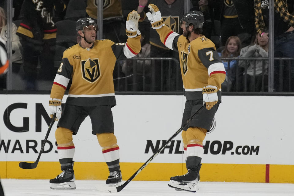 Vegas Golden Knights defenseman Alex Pietrangelo (7) celebrates after Vegas Golden Knights defenseman Alec Martinez, left, scored against the San Jose Sharks during the third period of an NHL hockey game Friday, Nov. 10, 2023, in Las Vegas. (AP Photo/John Locher)