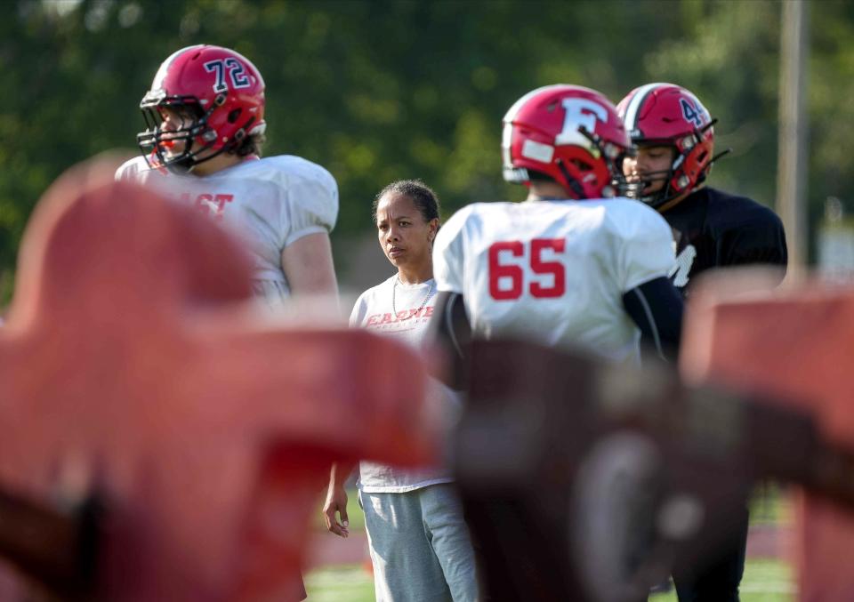 Des Moines East assistant football coach Renate Rice watches her players run drills during preseason practice earlier this month