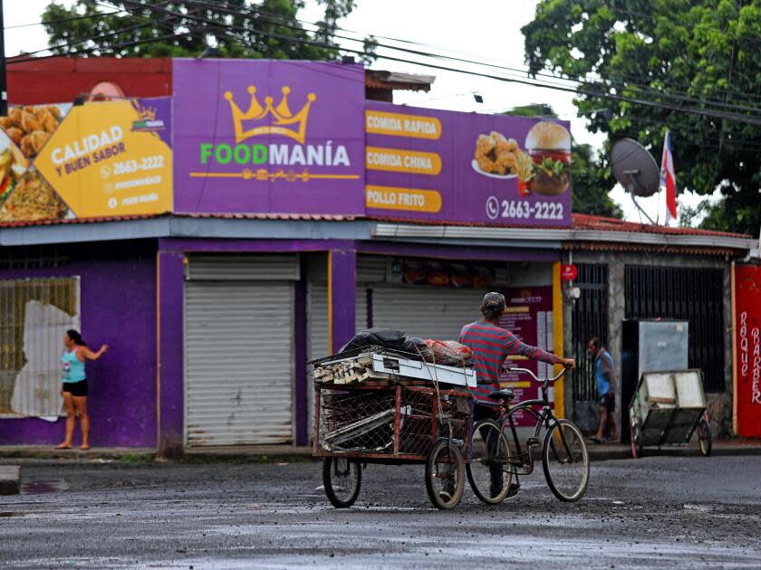 A bike peddles in front of the store where Kedwin Cordero Vega was shot and killed.