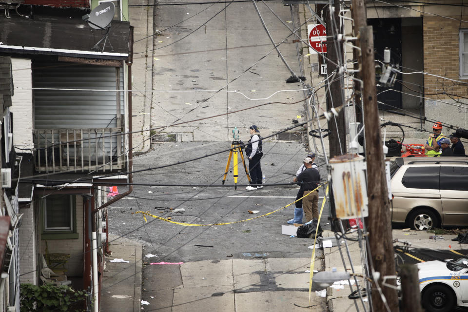 Authorities investigate the scene of this Saturday's fatal car explosion in Allentown, Pa., Monday, Oct. 1, 2018. (AP Photo/Matt Rourke)