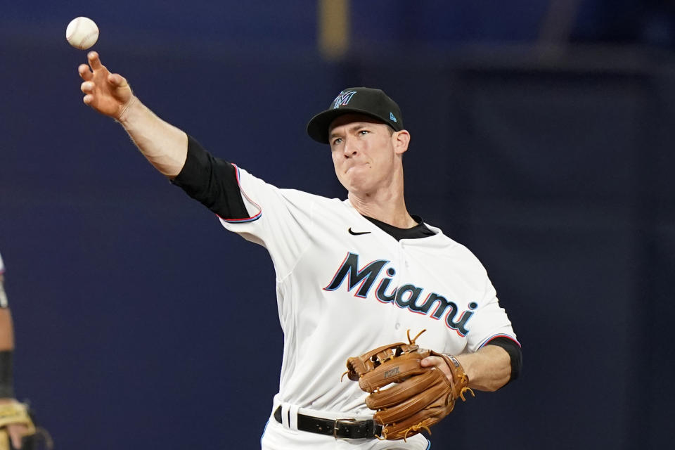 Miami Marlins third baseman Joey Wendle throws to first where St. Louis Cardinals' Yadier Molina was out during the fourth inning of a baseball game, Wednesday, April 20, 2022, in Miami. (AP Photo/Lynne Sladky)