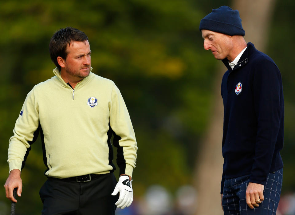 MEDINAH, IL - SEPTEMBER 28: Graeme McDowell of Europe (L) and Jim Furyk of the USA discuss the position of McDowell's golf ball on the second hole during the Morning Foursome Matches for The 39th Ryder Cup at Medinah Country Club on September 28, 2012 in Medinah, Illinois. (Photo by Jamie Squire/Getty Images)