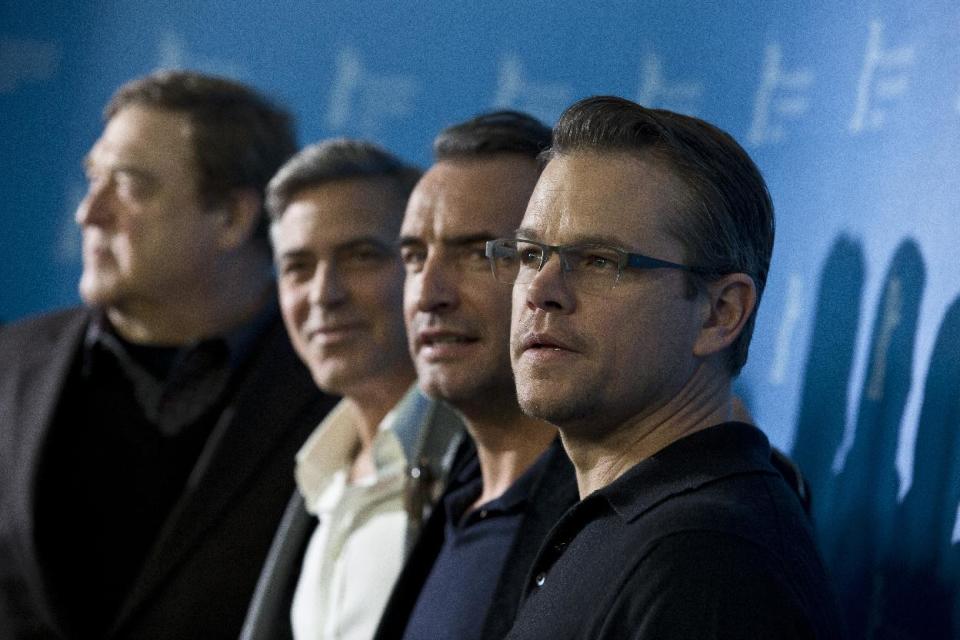 From right, actors Matt Damon, Jean Dujardin, George Clooney and John Goodman pose for photographers at the photo call for the film The Monuments Men during the 64th Berlinale International Film Festival on Saturday Feb. 8, 2014, in Berlin. (AP Photo/Axel Schmidt)